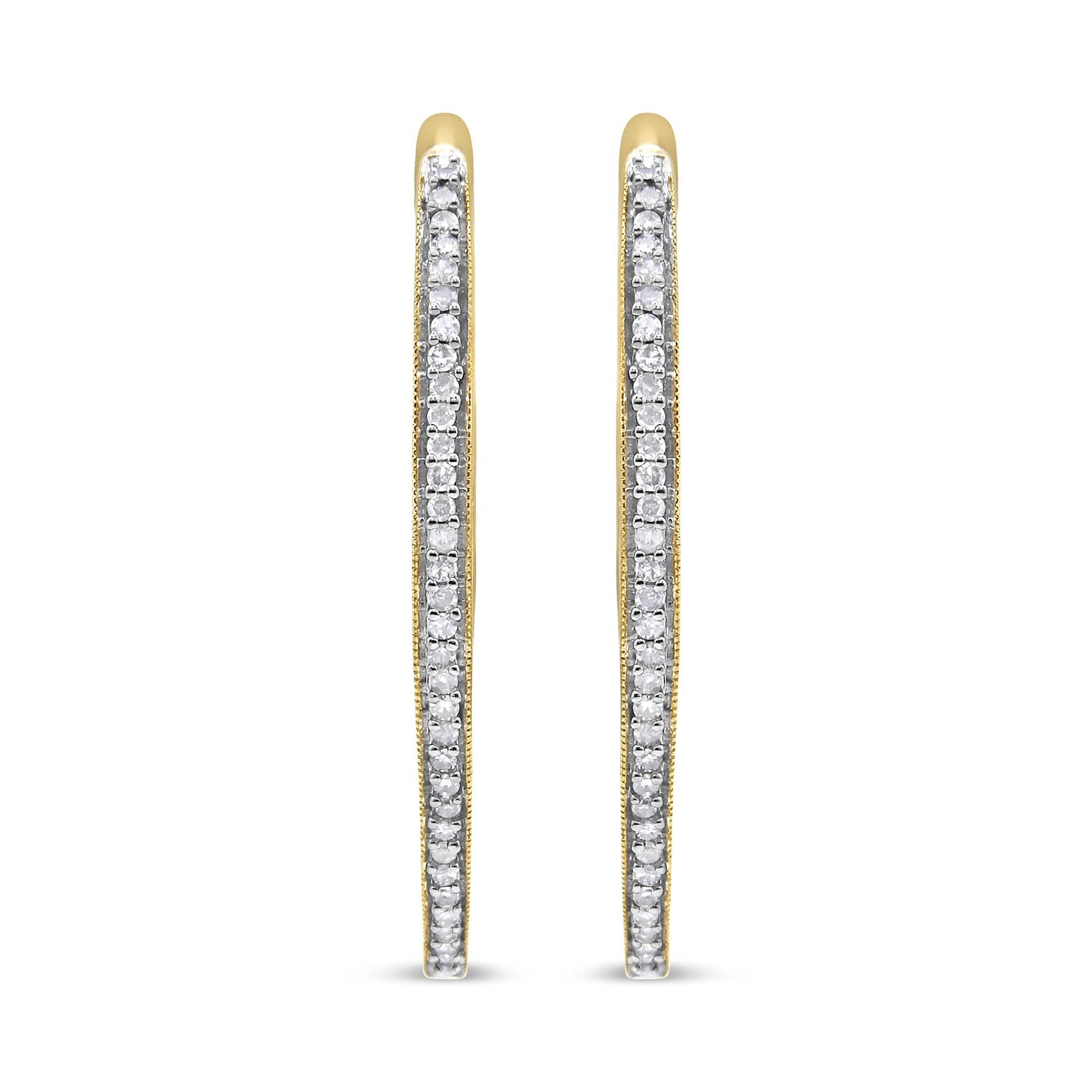 Front view of slim yellow metal hoop earrings lined with prong-set round white gemstones.