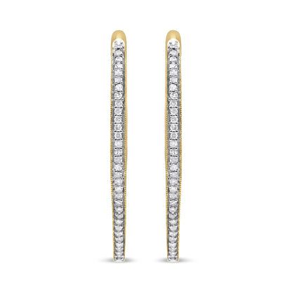 Front view of slim yellow metal hoop earrings lined with prong-set round white gemstones.