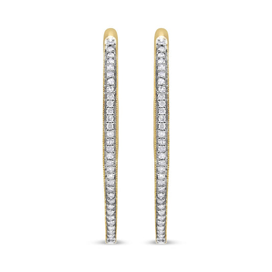 Front view of slim yellow metal hoop earrings lined with prong-set round white gemstones.