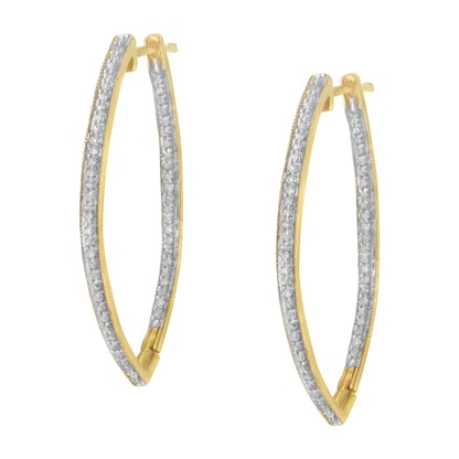 Pair of elongated yellow metal hoop earrings with rows of white round gemstones in prong settings, shown from a front angle.