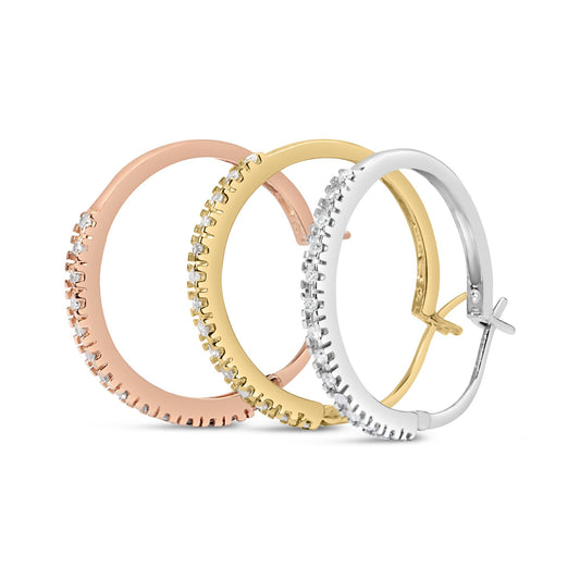 Three hoop earrings in yellow, white, and rose metal colors with prong-set round white gemstones along the outer edges, shown from a side angle.