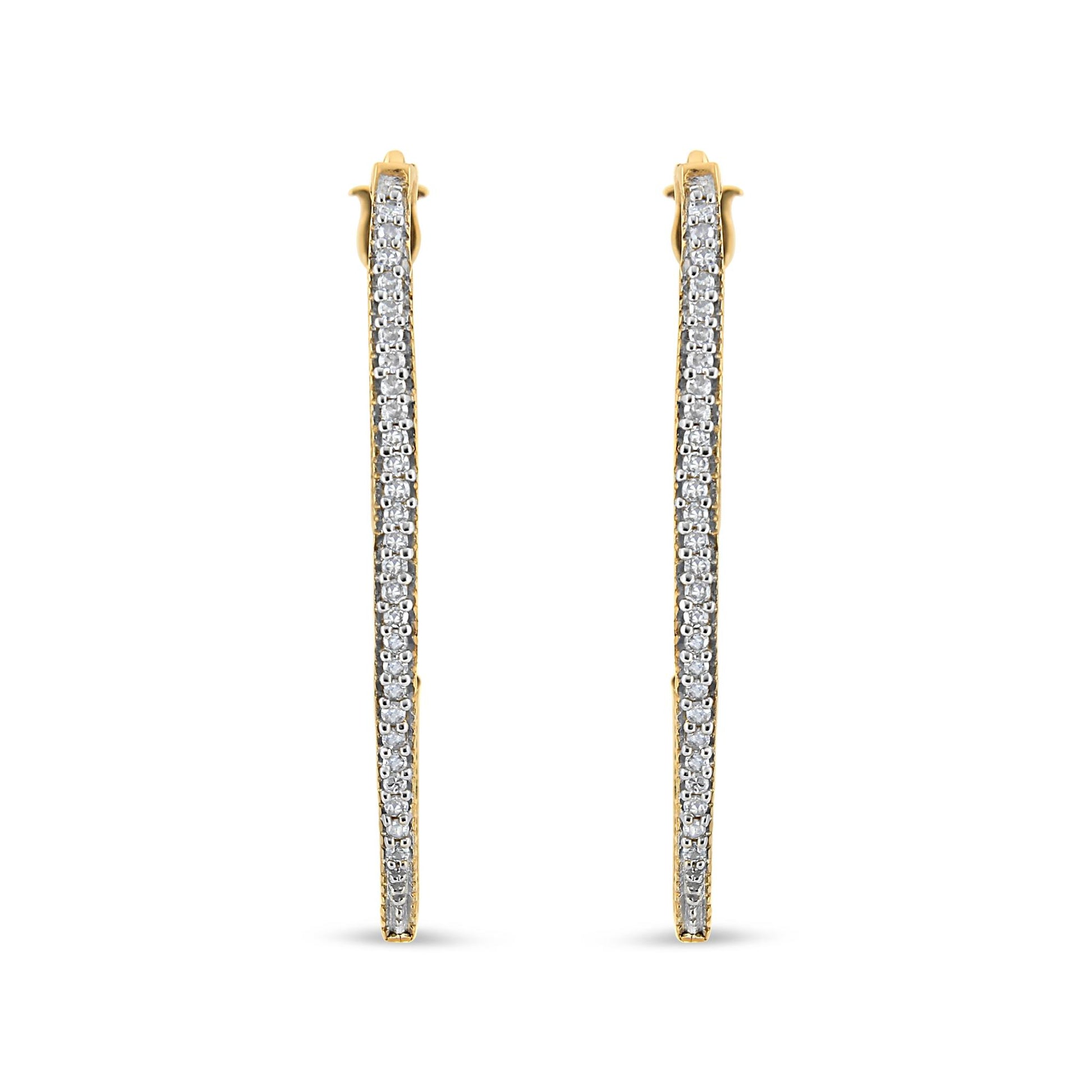 Front-facing view of yellow metal earrings with a single row of round white gemstones in prong setting along the length.