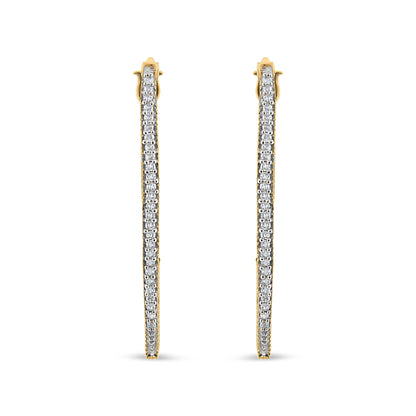 Front-facing view of yellow metal earrings with a single row of round white gemstones in prong setting along the length.