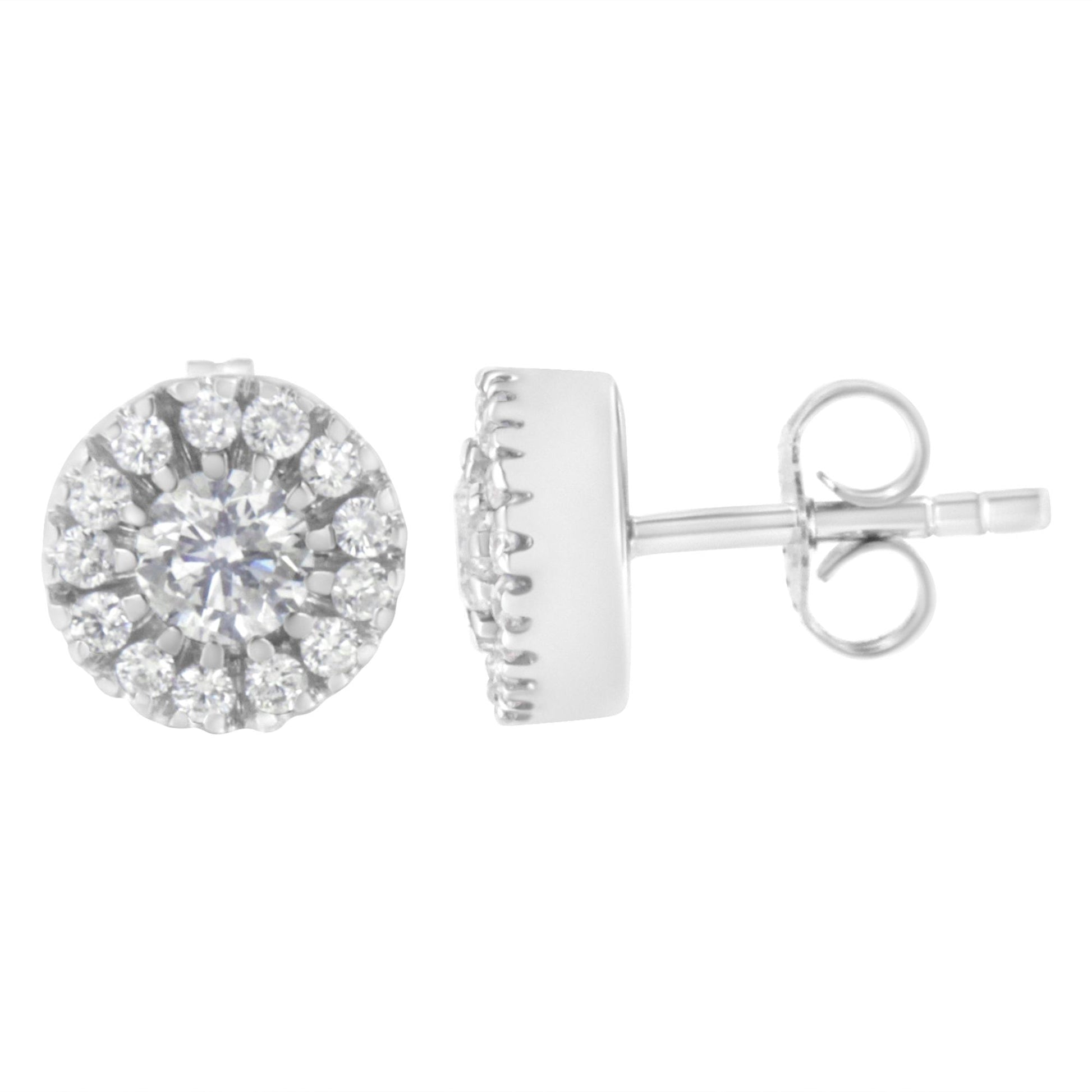 Pair of white metal stud earrings with central round prong-set white gemstones surrounded by pave-set white gemstones, shown from front and side angle.