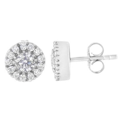 Pair of white metal stud earrings with central round prong-set white gemstones surrounded by pave-set white gemstones, shown from front and side angle.