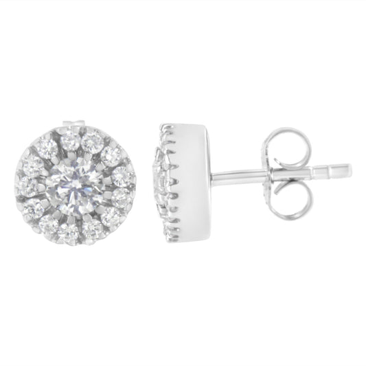 Pair of white metal stud earrings with central round prong-set white gemstones surrounded by pave-set white gemstones, shown from front and side angle.