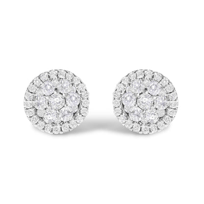 Front-facing view of a pair of white metal round stud earrings, each featuring multiple small white gemstones in shared prong and tension settings forming a clustered circular design.