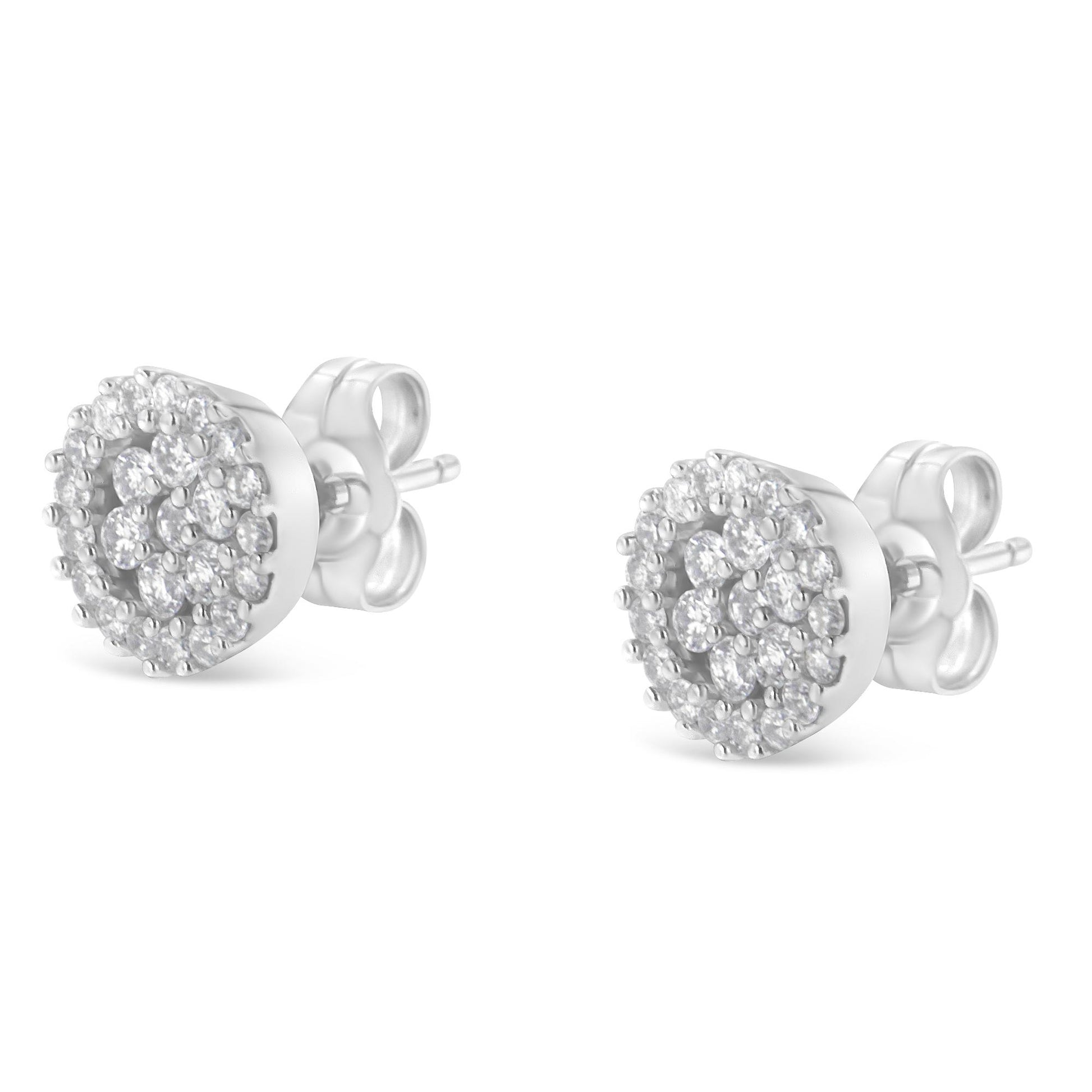 Pair of white metal round stud earrings with prong-set white gemstones, shown from a front angle.