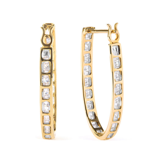 Pair of yellow metal hoop earrings with white baguette-shaped gemstones in channel settings, shown from a front angle.