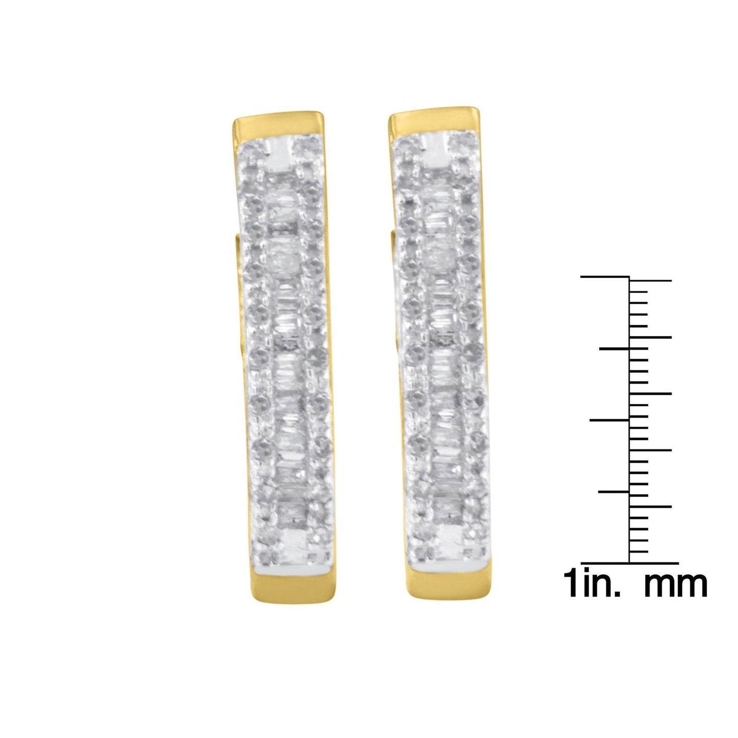 Front view of a pair of yellow metal earrings with rows of white round gemstones in prong settings and white baguette gemstones in channel settings, shown next to a ruler for size reference.