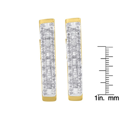 Front view of a pair of yellow metal earrings with rows of white round gemstones in prong settings and white baguette gemstones in channel settings, shown next to a ruler for size reference.