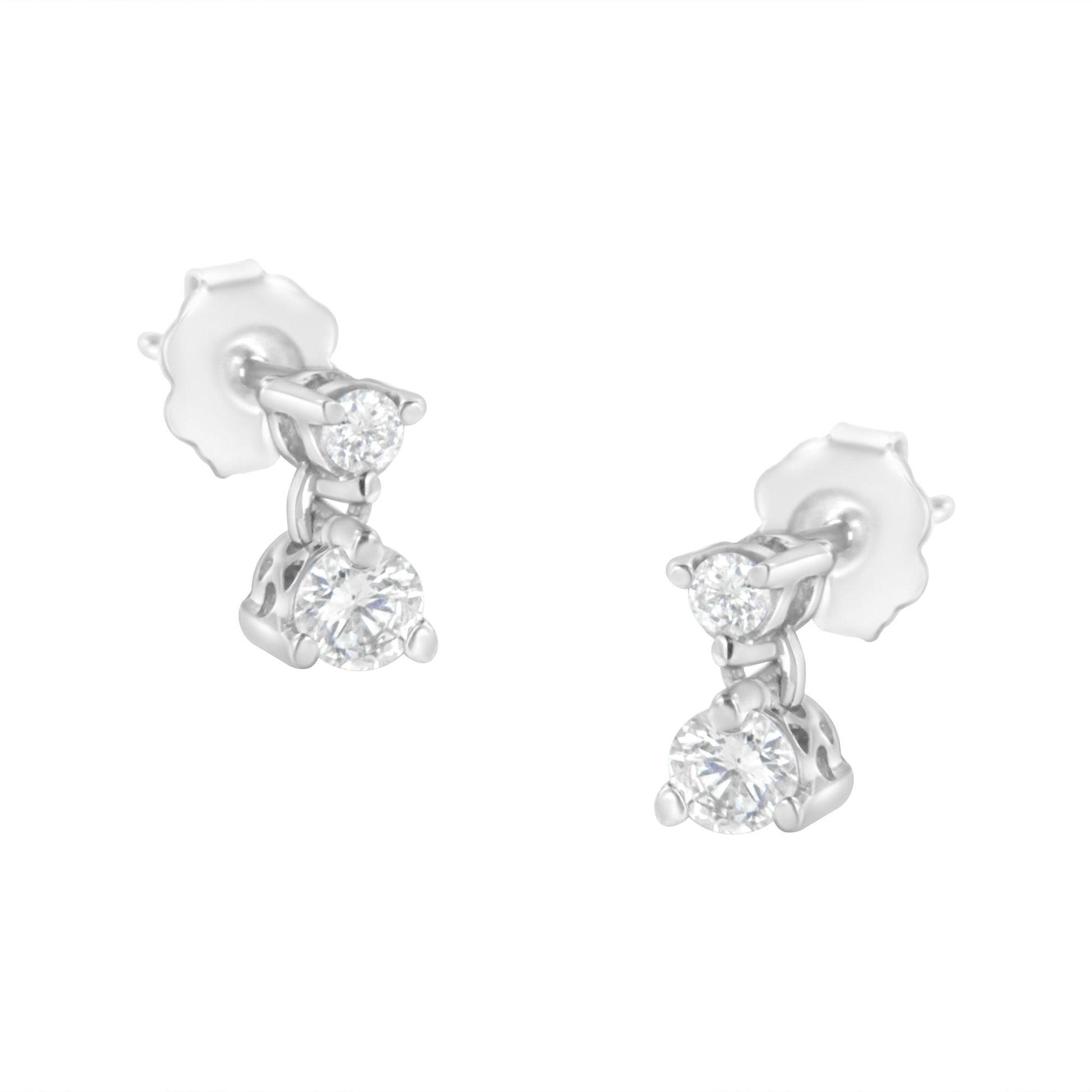 Pair of white metal earrings with two round white gemstones in prong settings, shown from a slightly angled front view.