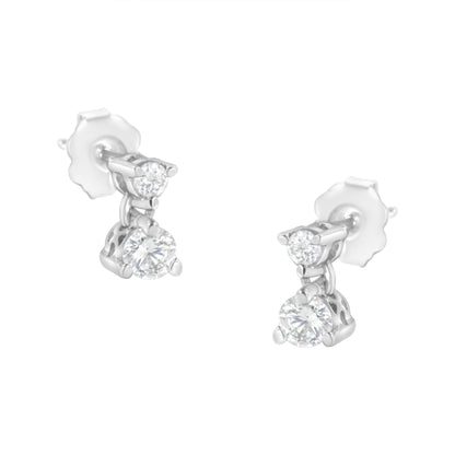 Pair of white metal earrings with two round white gemstones in prong settings, shown from a slightly angled front view.
