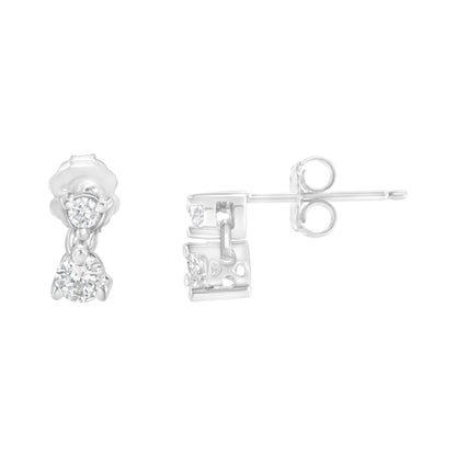 Pair of white metal earrings with round white gemstones in prong settings, shown from front and side angles on a white background.