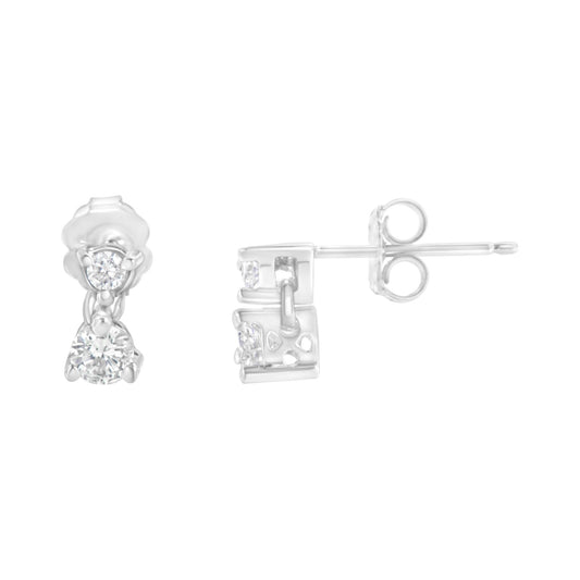 Pair of white metal earrings with round white gemstones in prong settings, shown from front and side angles on a white background.
