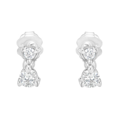 Front view of a pair of white metal earrings each featuring two round white gemstones in prong settings.