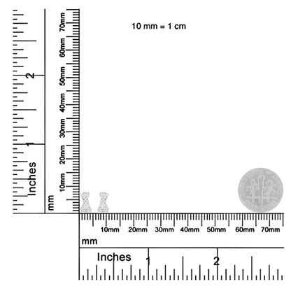 Pair of white metal earrings with round white gemstones in prong settings, shown from front on a ruler for size reference.