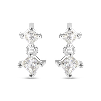 Front view of a pair of white metal earrings with two princess-shaped white gemstones in prong settings connected by a small link.