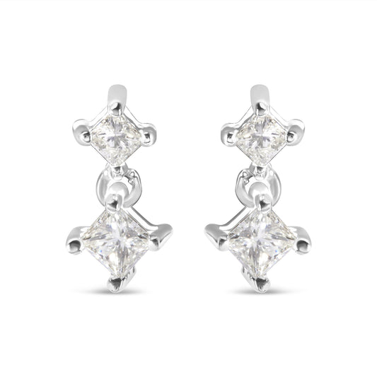 Front view of a pair of white metal earrings with two princess-shaped white gemstones in prong settings connected by a small link.