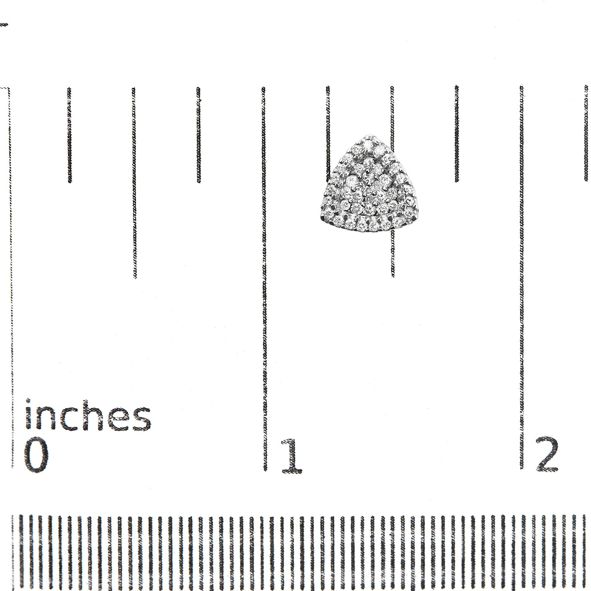 Close-up front view of a triangular white metal earring with multiple white round gemstones in prong settings, placed on a ruler for size reference.