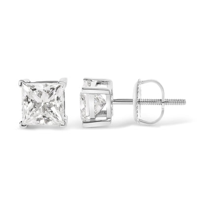 Close-up front and side view of white metal stud earrings with princess shape red gemstones in 4-prong settings.