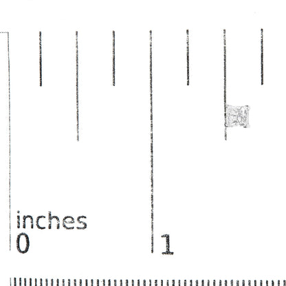 Close-up front view of a white metal earring with a princess-shaped white gemstone in a four-prong setting, placed on a ruler for size reference.
