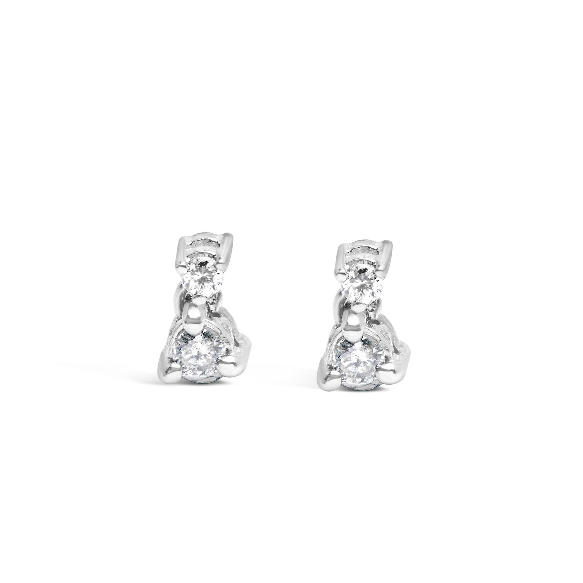 Front-facing view of a pair of white metal earrings, each featuring two round white gemstones set in three-prong settings.