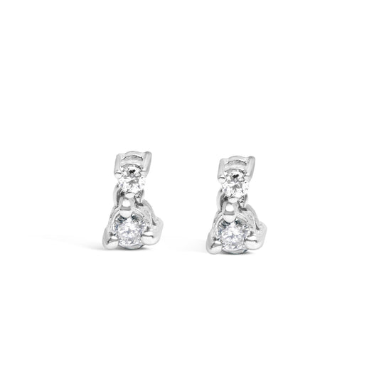 Front-facing view of a pair of white metal earrings, each featuring two round white gemstones set in three-prong settings.