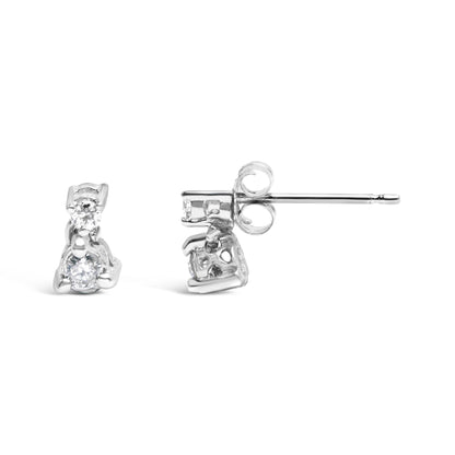 Front and side view of white metal stud earrings with two round white gemstones in three-prong settings.