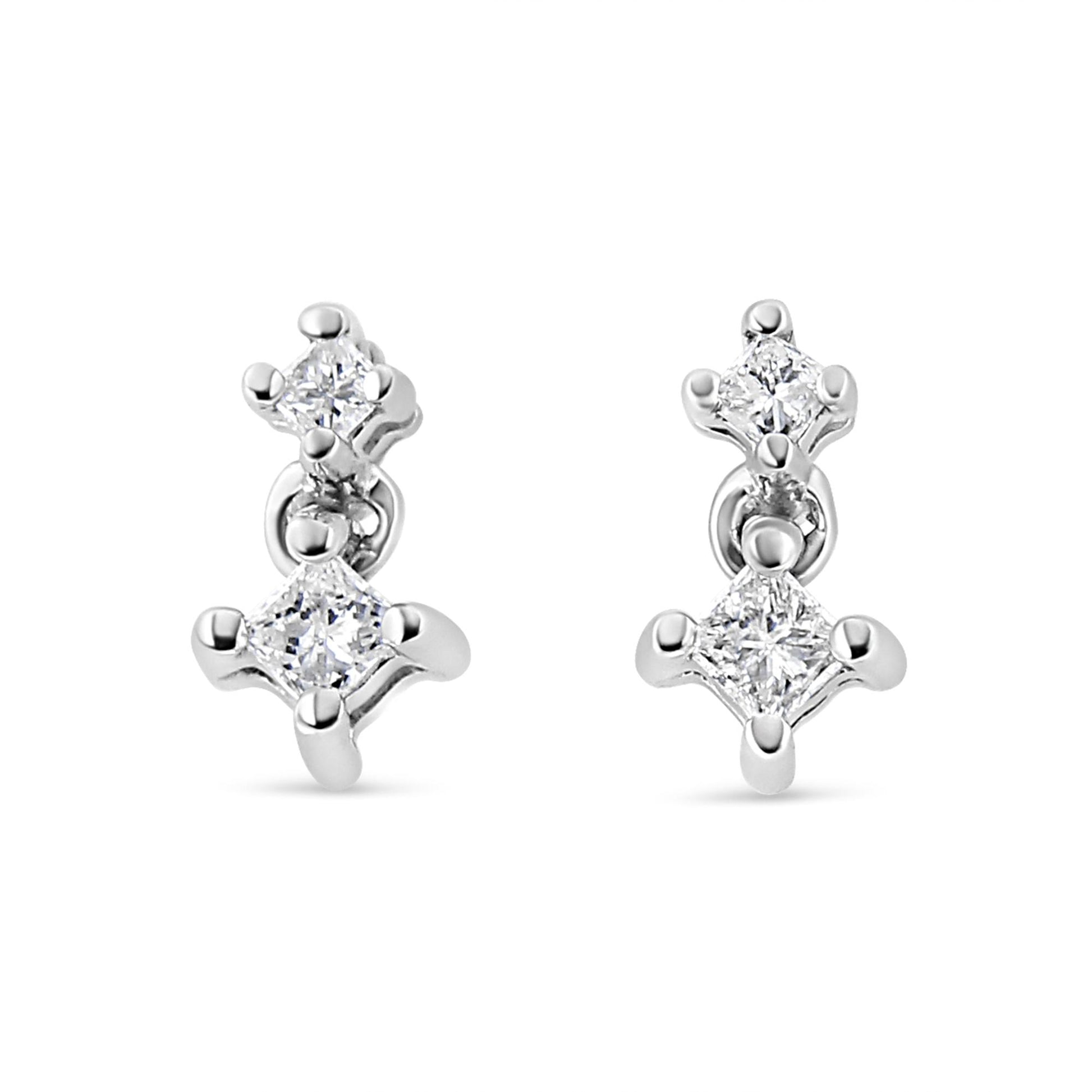 Front view of white metal earrings featuring two princess-shaped white gemstones in prong settings on each earring.