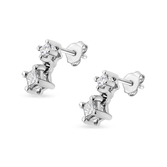 Pair of white metal stud earrings with four white princess-shaped gemstones in prong settings, shown at an angle.
