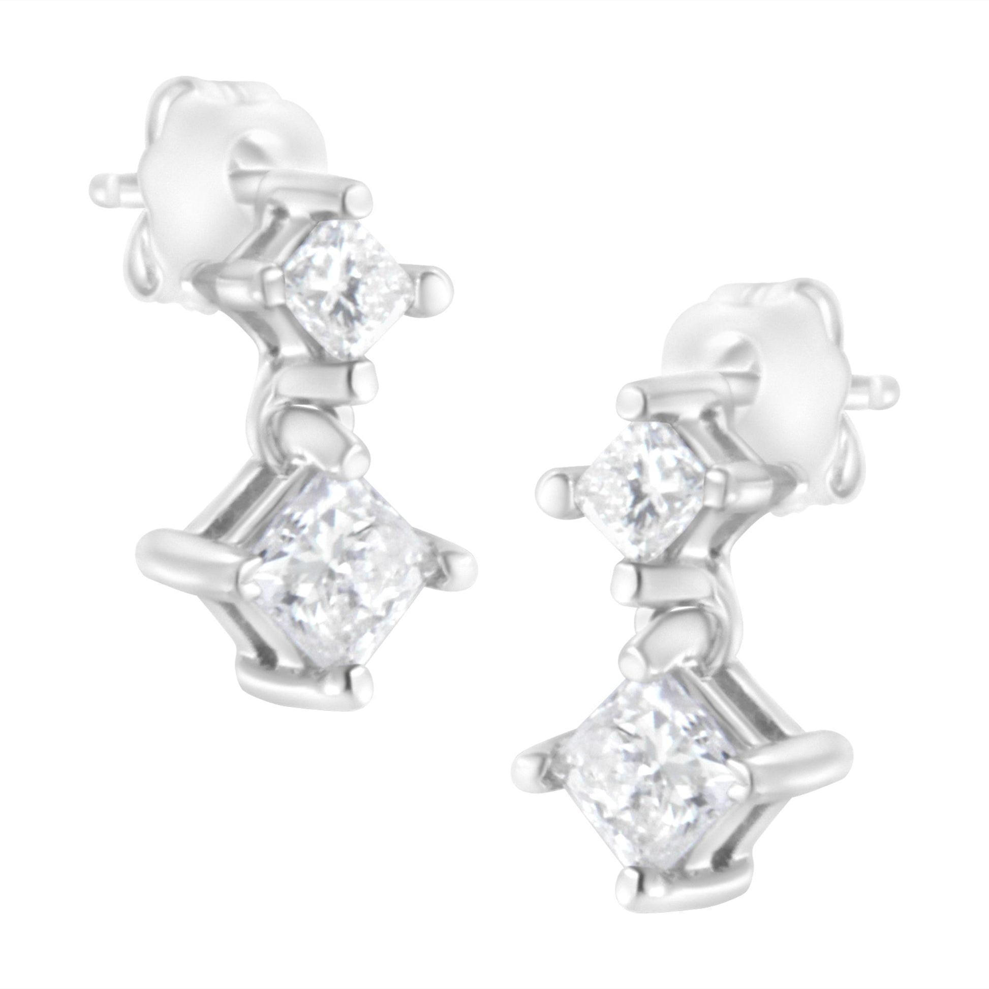 Close-up front angle of white metal earrings with two prong-set princess-shaped white gemstones on each earring.
