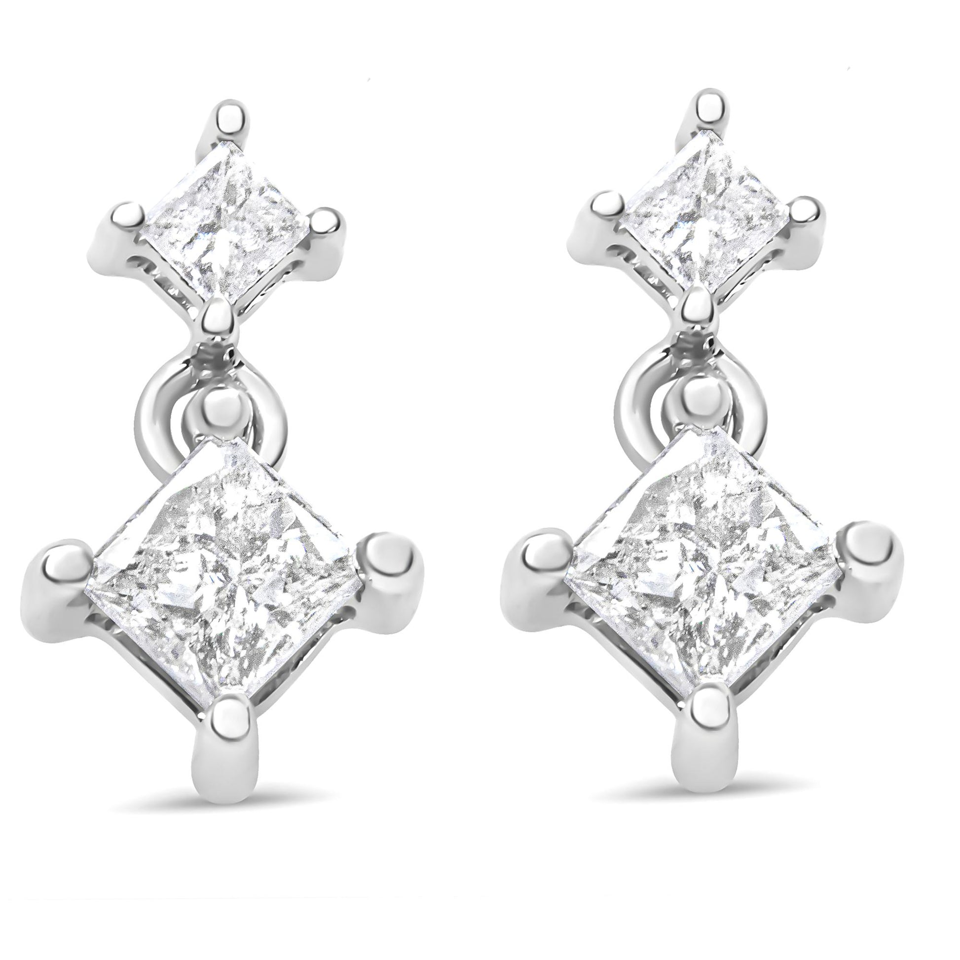 Front view of a pair of white metal earrings each featuring two princess-shaped white gemstones in prong settings.