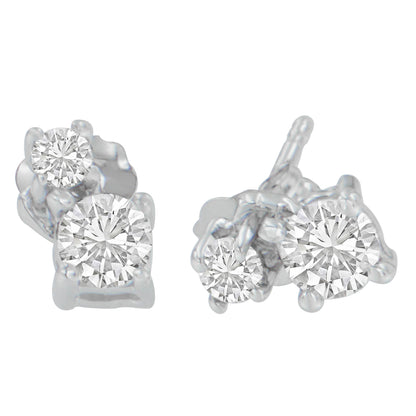 Close-up front angle of white metal stud earrings each with two prong-set round white gemstones.