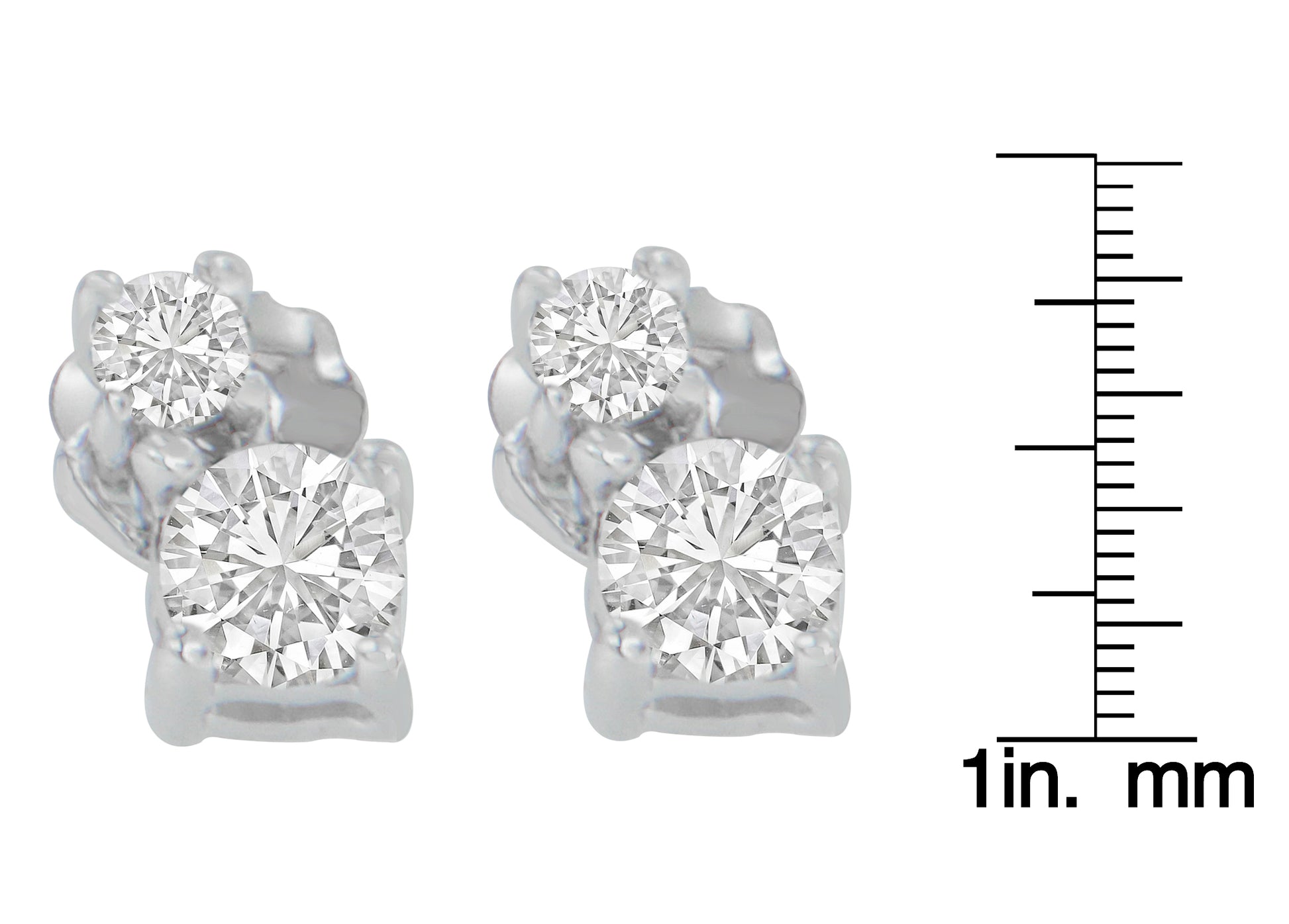Close-up front view of white metal earrings with two round white gemstones in prong settings, shown next to a ruler for size reference.