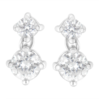 Front angle view of white metal earrings with two round white gemstones each in prong settings.
