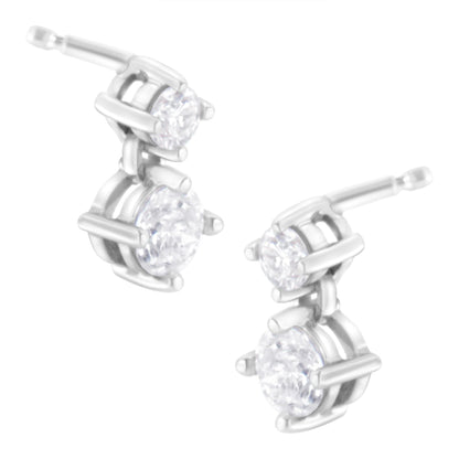 Pair of white metal earrings with two round white gemstones in prong settings, shown from a front angle.