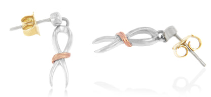 Two-toned earrings with an infinity loop design, featuring a rose-toned accent around the center, shown from a side angle.