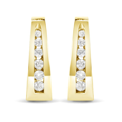 Front view of yellow metal earrings with a vertical row of round white gemstones in channel setting.