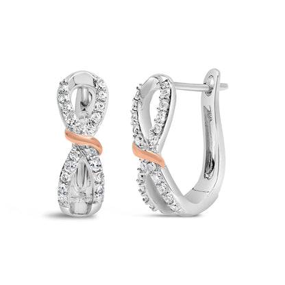 Front and side view of white and rose metal earrings with an infinity design, adorned with round white gemstones in prong settings.