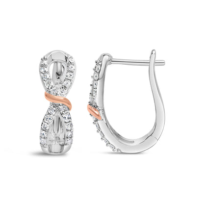 Front and side views of white and rose metal earrings with an infinity shape, featuring round white gemstones in prong settings along the front.