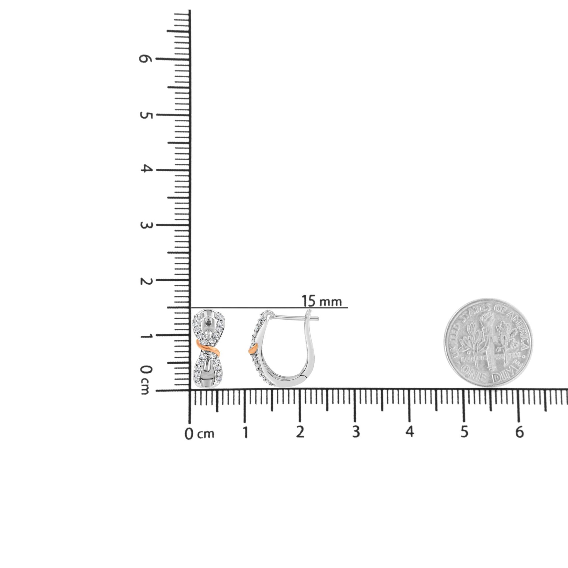 Front and side view of white and rose metal earrings with round white gemstones in prong setting, placed on ruler and next to a dime for size reference.