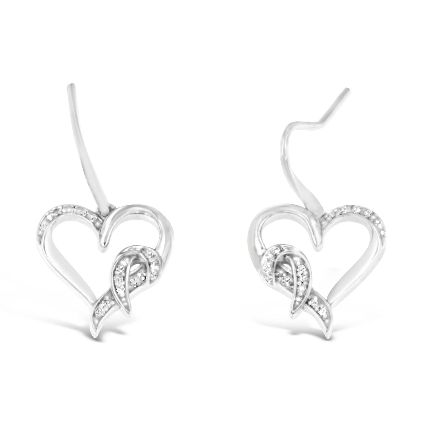 Pair of white metal heart-shaped earrings with pave-set round white gemstones, shown from a front angle.