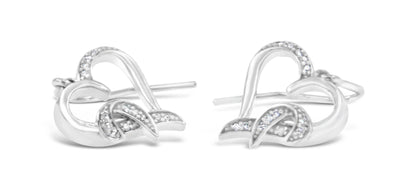 Pair of white metal earrings with curved, intertwined design accented with small white gemstones in a pave setting, front angle.