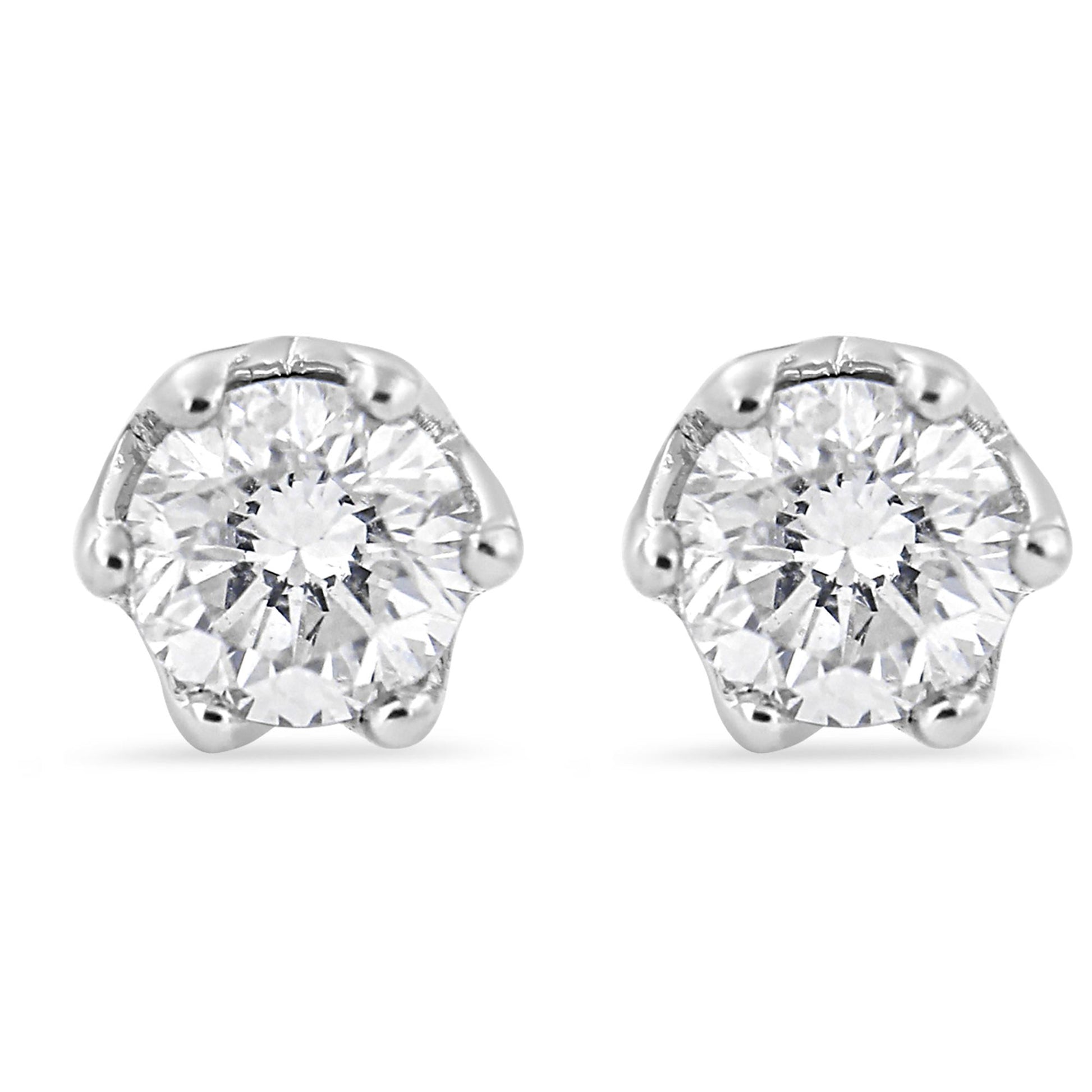Front view of white stud earrings each featuring a round white gemstone in six-prong setting.