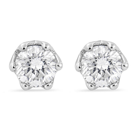 Front view of white stud earrings each featuring a round white gemstone in six-prong setting.