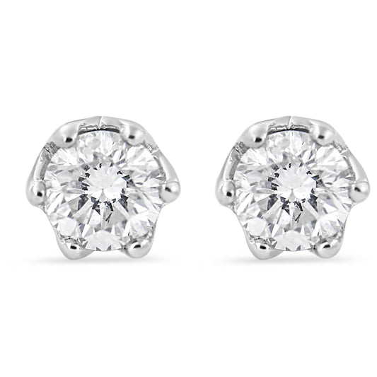 Front view of white stud earrings each featuring a round white gemstone in six-prong setting.