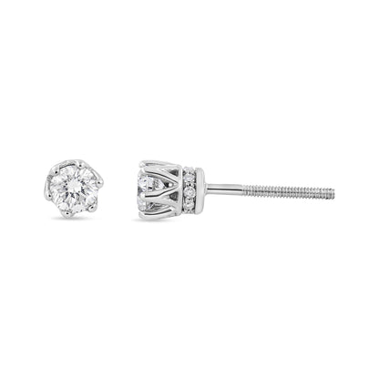 Close-up front and side view of white metal stud earrings featuring round white gemstones in six-prong and pave settings.