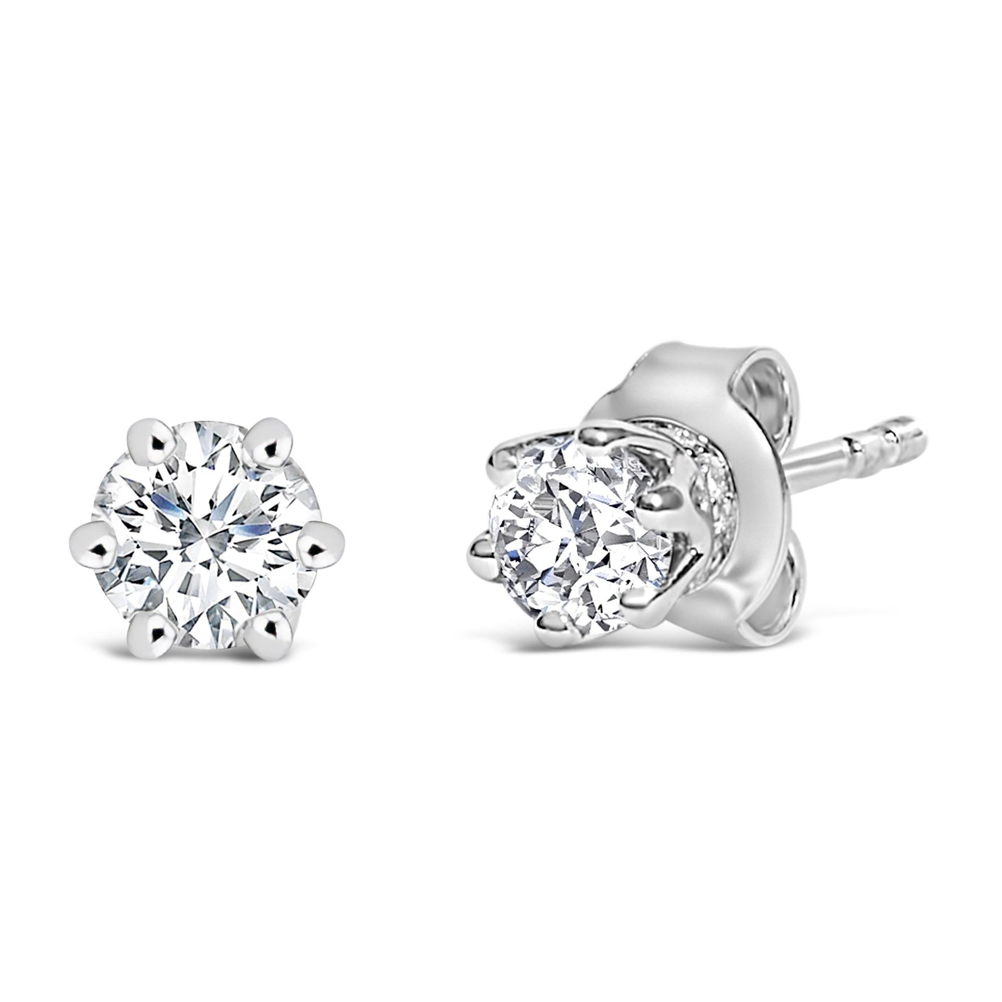 Close-up front and side view of a pair of white stud earrings featuring round white gemstones in six-prong and pave settings.