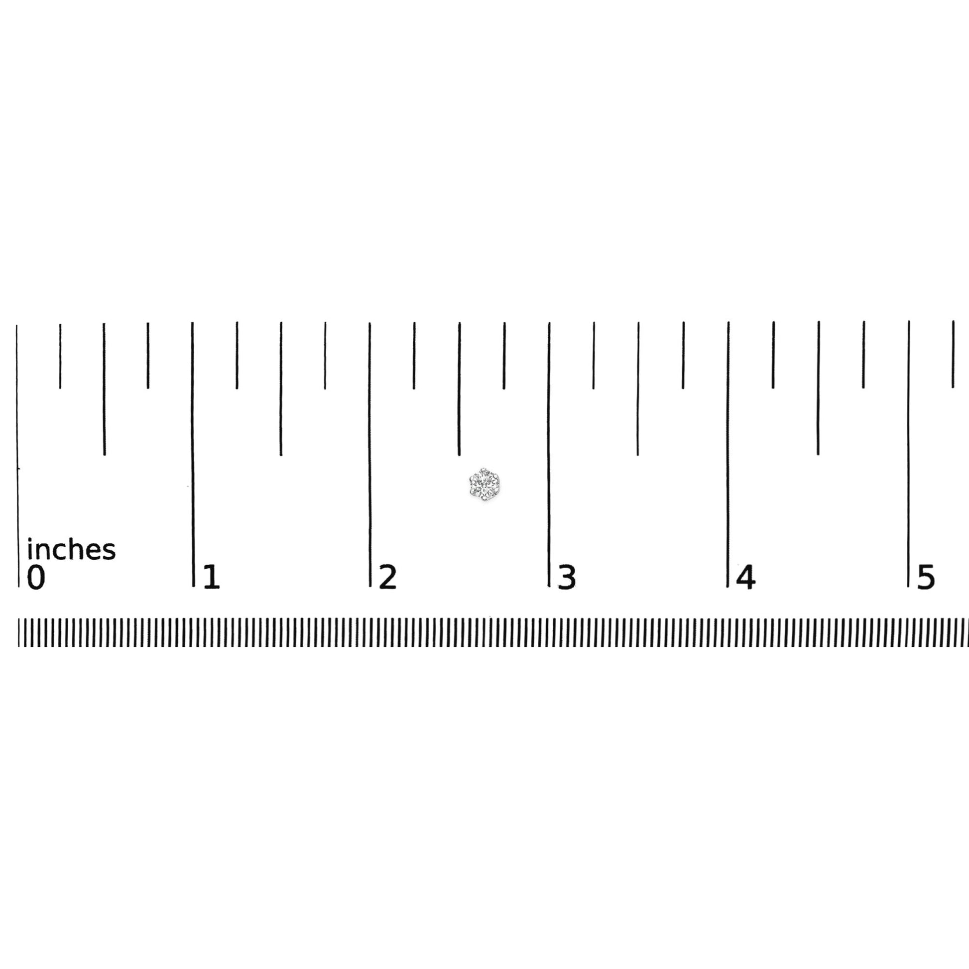 White metal stud earring with a central round white gemstone in six-prong setting surrounded by smaller round white gemstones in pave setting, shown on a ruler for size reference, top view.